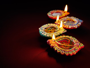 Wall Mural - Colorful clay diya lamps lit during diwali celebration