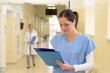 © CandyBox Images - Nurse in hospital looking at file