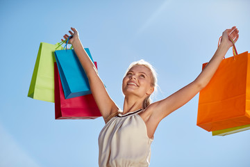 Sticker - smiling woman with shopping bag rising hands