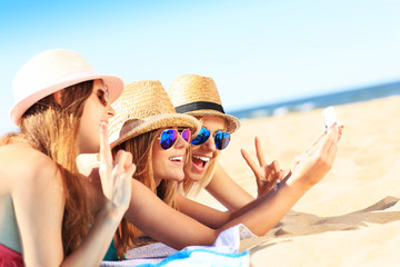 Wall Mural - Group of friends taking selfie on the beach