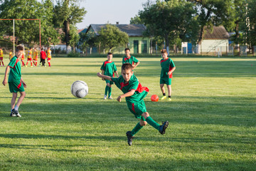 Wall Mural -  Boys kicking ball at goal