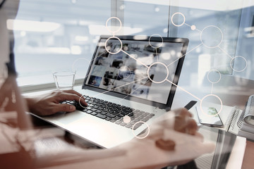 double exposure of business man hand working on laptop computer