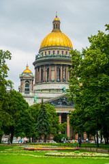 Wall Mural - St. Isaac's Cathedral with its Golden dome on the background of green trees.