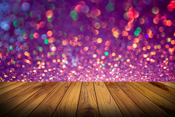 Wall Mural - bokeh lights background with multi colors with motion blur and wood floor