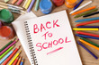 © david_franklin - Back to school word writing written on open notebook book student desk surrounded by pencils and crayons photo