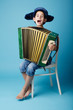 little accordion player on blue background