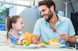 © WavebreakmediaMicro - Daughter and father eating at the restaurant