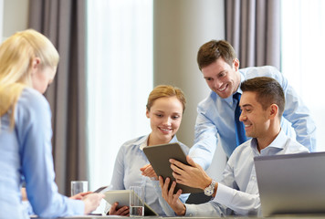 Wall Mural - smiling business people with tablet pc in office