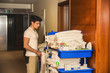 © theartofphoto - Young man pushing a housekeeping cart in a hotel