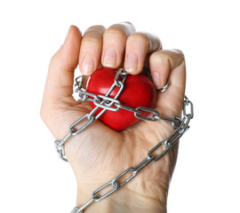 Heart shape with metal chain in female hand, isolated on white