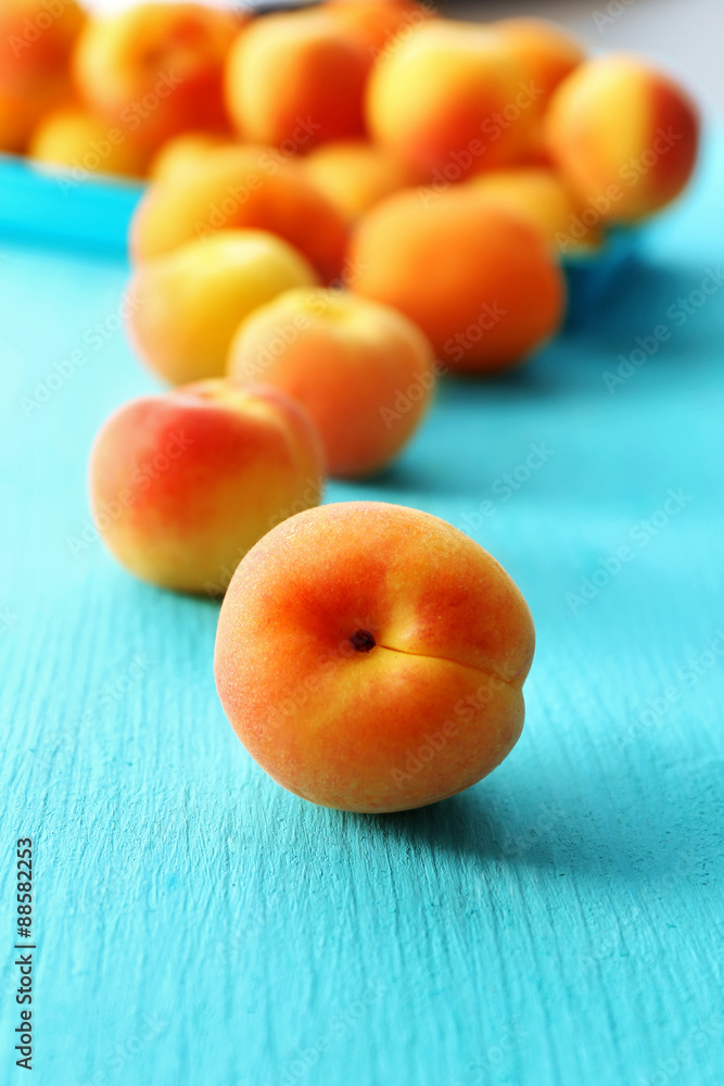 Ripe apricots on wooden table close up