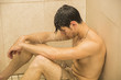 © theartofphoto - Sad Young Man Taking Shower, Sitting on Floor