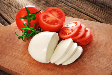 Wall Mural - Mozzarella cheese with tomatoes and rosemary.