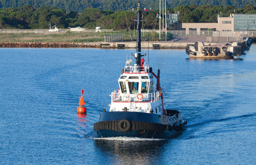 Tug boat goes on a fairway in Porto-Vecchio