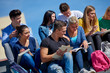 © .shock - students outside sitting on steps