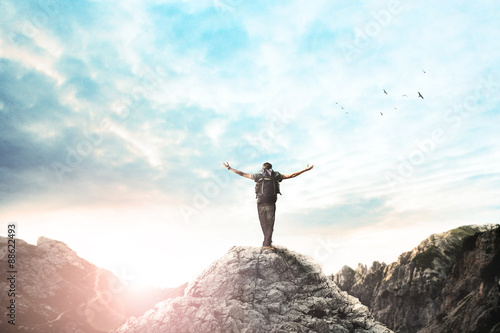 Fényképezés  Man on the top of the mountain exulting at sunset