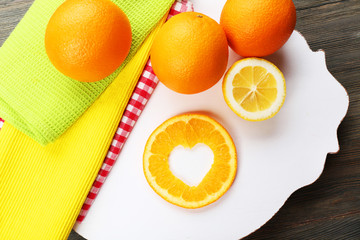 Poster - Orange slice with cut in shape of heart on table close up