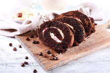 Delicious Chocolate Roll On Wooden Cutting Board, Closeup