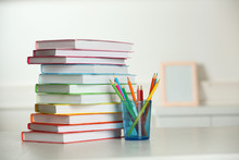 Colorful Books And Pencil On Table In Room
