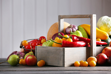 Heap of fresh fruits and vegetables on wooden background