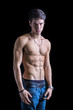 © theartofphoto - Handsome, fit shirtless young man in jeans isolated on black