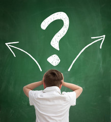 Wall Mural - schoolboy thinking with question marks overhead