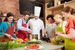 © Syda Productions - happy friends and chef cook cooking in kitchen