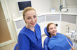 © Syda Productions - happy female dentist with patient girl at clinic