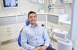 © Syda Productions - happy male patient sitting on dental chair