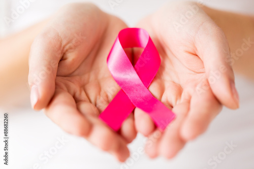 Fotografie, Obraz close up of hands and pink cancer awareness ribbon