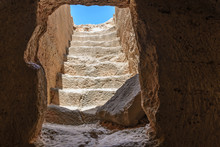 View Looking Out The Exit Tunnel Of An Ancient Stone Burial Tomb In Paphos, Cyprus.