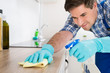 © Andrey Popov - Worker Cleaning Countertop With Rag
