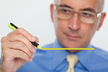 Man using a highlight marker on glass board