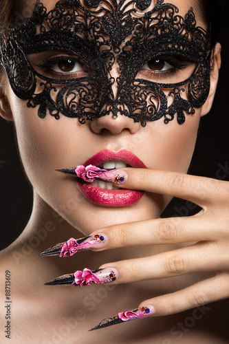 Leinwand Poster Beautiful girl in mask with long nails and sensual lips. Beauty