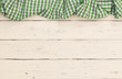 © vulcanus - Checkered tablecloth on wooden table