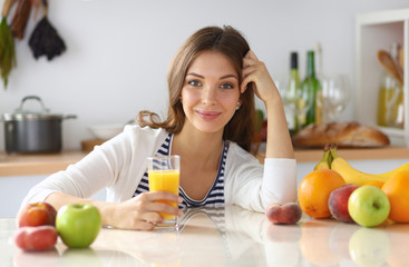 Portrait of a pretty woman holding glass with tasty juice