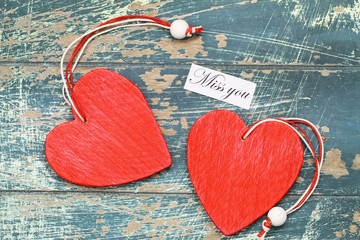 Wall Mural - miss you card with two red wooden hearts on rustic surface