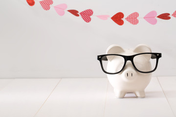 Wall Mural - Piggy bank wearing black glasses