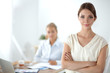 © lenets_tan - Attractive businesswoman standing near wall in office