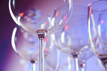 empty wine glasses on color background