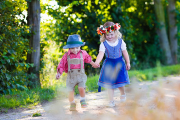 Kids in Bavarian costumes in wheat field