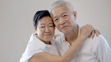 Happy Asian senior couple on white background love and hug