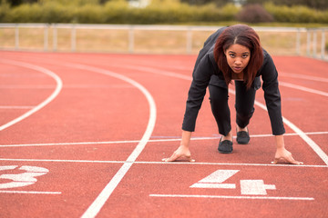 Wall Mural - Businesswoman in a Start Position on Race Track