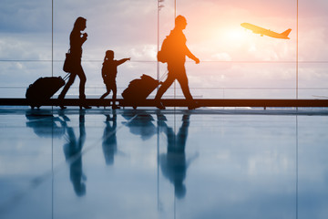 sihouette of young family and airplane