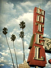 Wall Mural - aged and worn vintage photo of motel sign palm trees