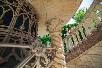 Wall Mural - Bride and groom on the stairs of the castle