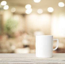 Coffee Cup On Wood Table Over Blurred Cafe  Background