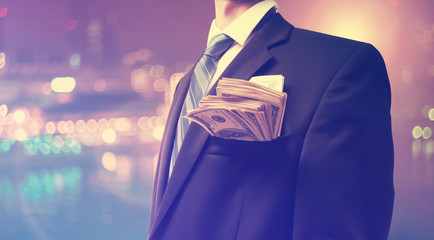 businessman with wad of cash
