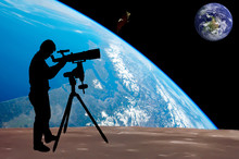 Silhouette Of Young Man Looking Through A Telescope At To The Ea