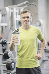 Wall Mural - smiling man with protein shake bottle